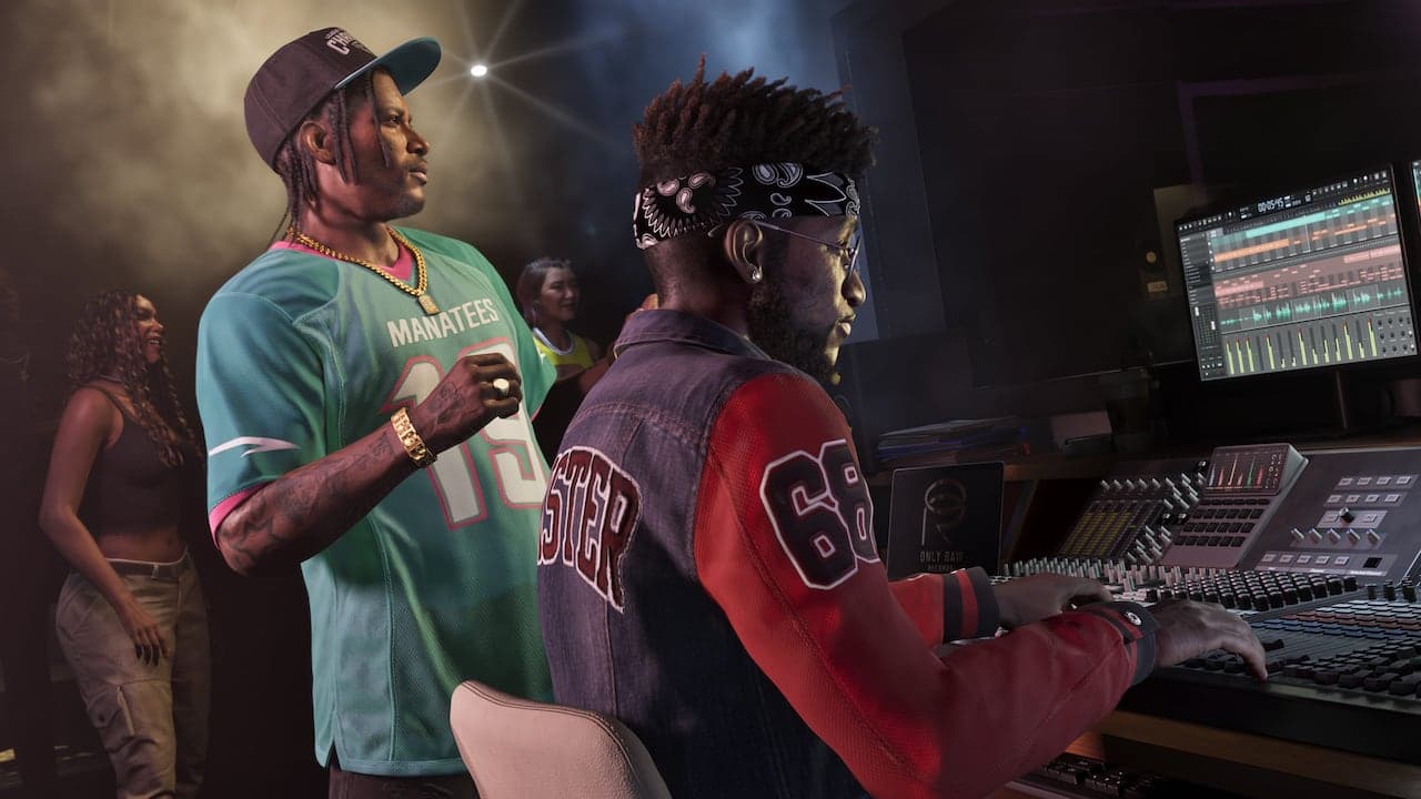 Dre'Quan standing over a mixing desk in a recording studio, directing an engineer seated at the faders.
