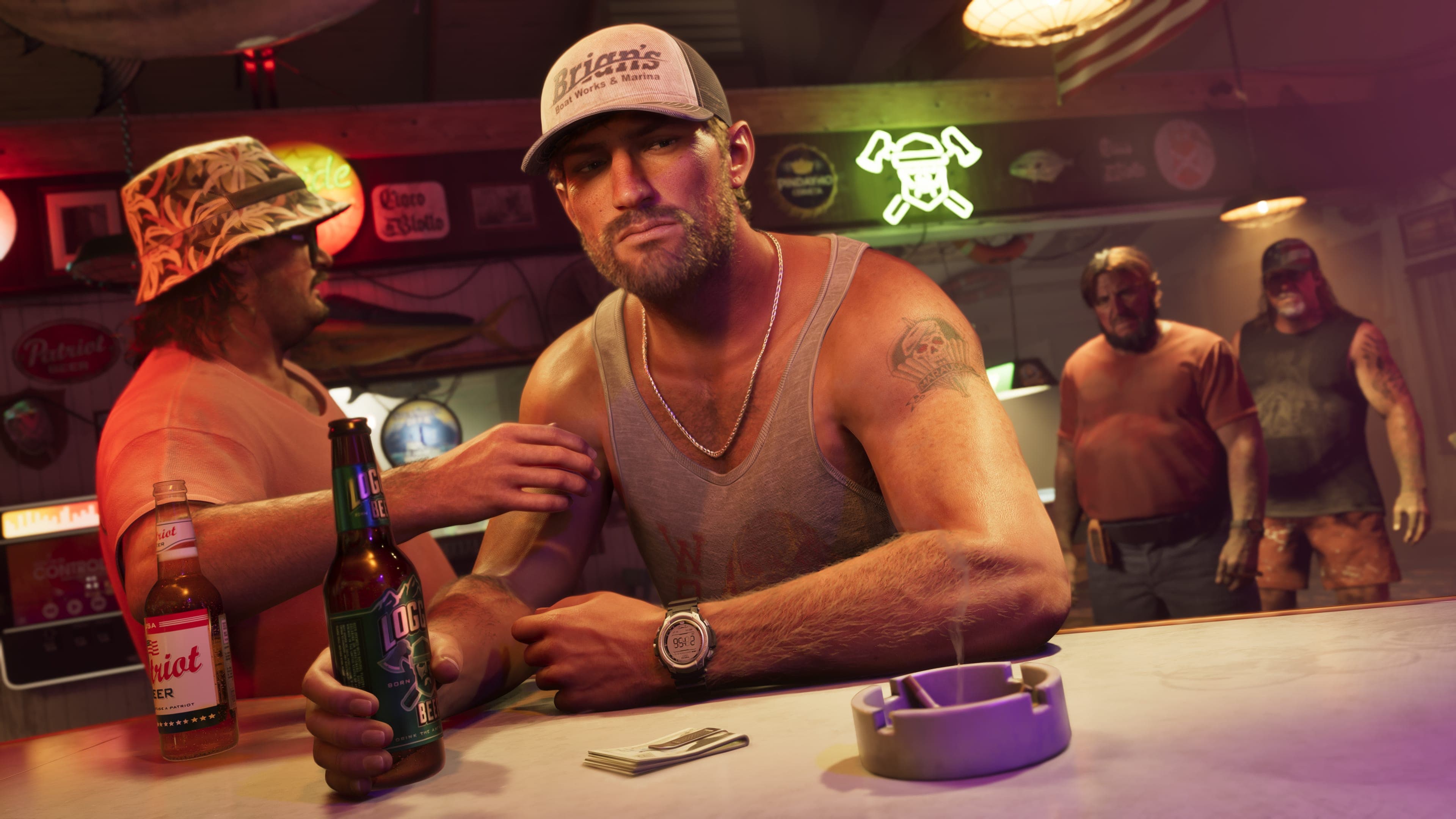 Jason leaning on a bar counter in a cap and vest, looking at the camera, neon signs and other drinkers behind him.
