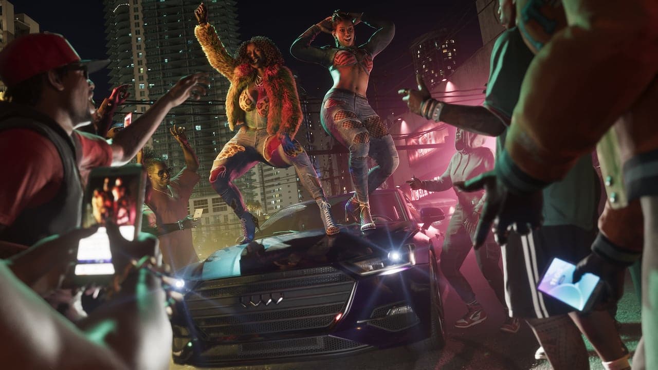 Real Dimez dancing on the bonnet of a car at a street party at night, a crowd filming them on phones.