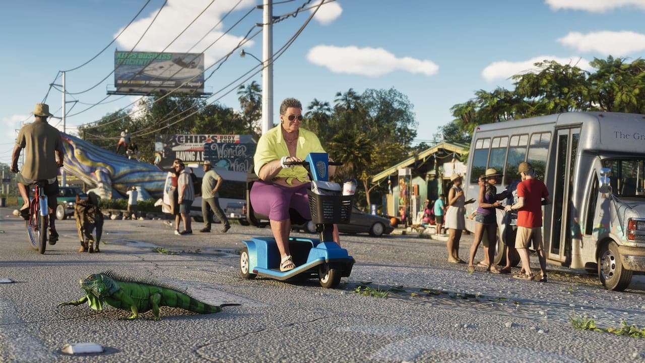 A Keys roadside in the afternoon, an iguana crossing the tarmac ahead of a mobility scooter, with a minibus and a row of shopfronts behind.