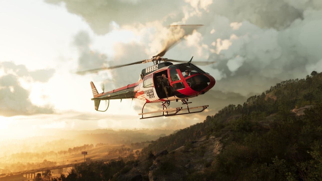 A news helicopter banking over the wooded ridges of Mount Kalaga National Park at golden hour.