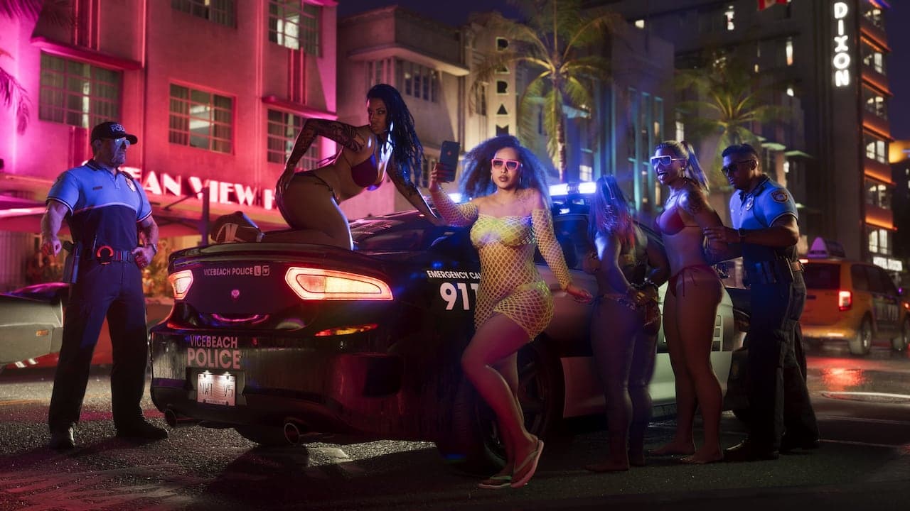 A neon-lit Vice City street at night outside the Ocean View Hotel, police officers standing by a patrol car as a group gathers around it.