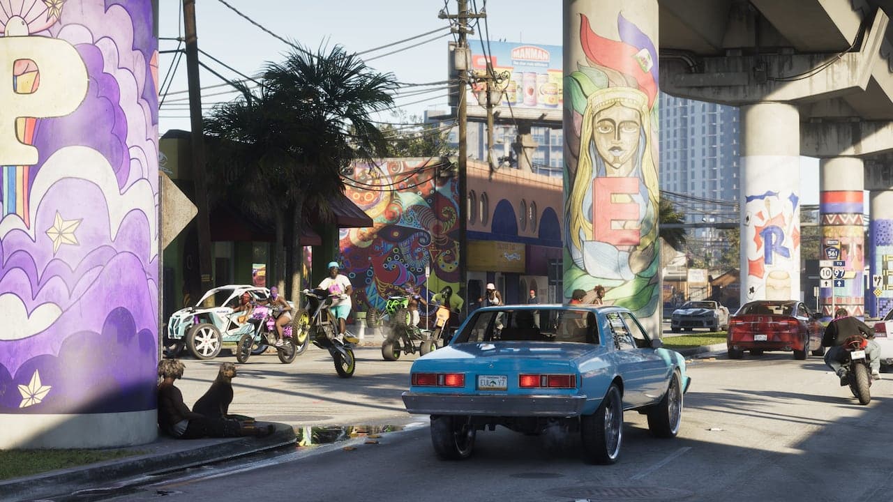 A Vice City street beneath a raised expressway, its support columns painted with murals, dirt bikes and a classic saloon on the road.