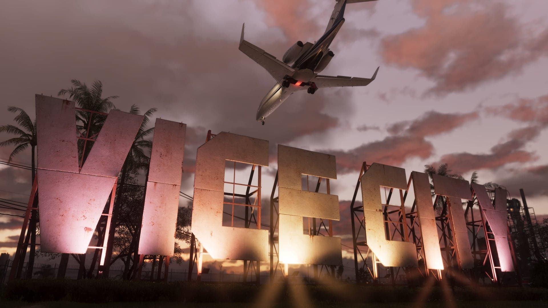 The Vice City sign lit against a pink sunset as an airliner passes low overhead.