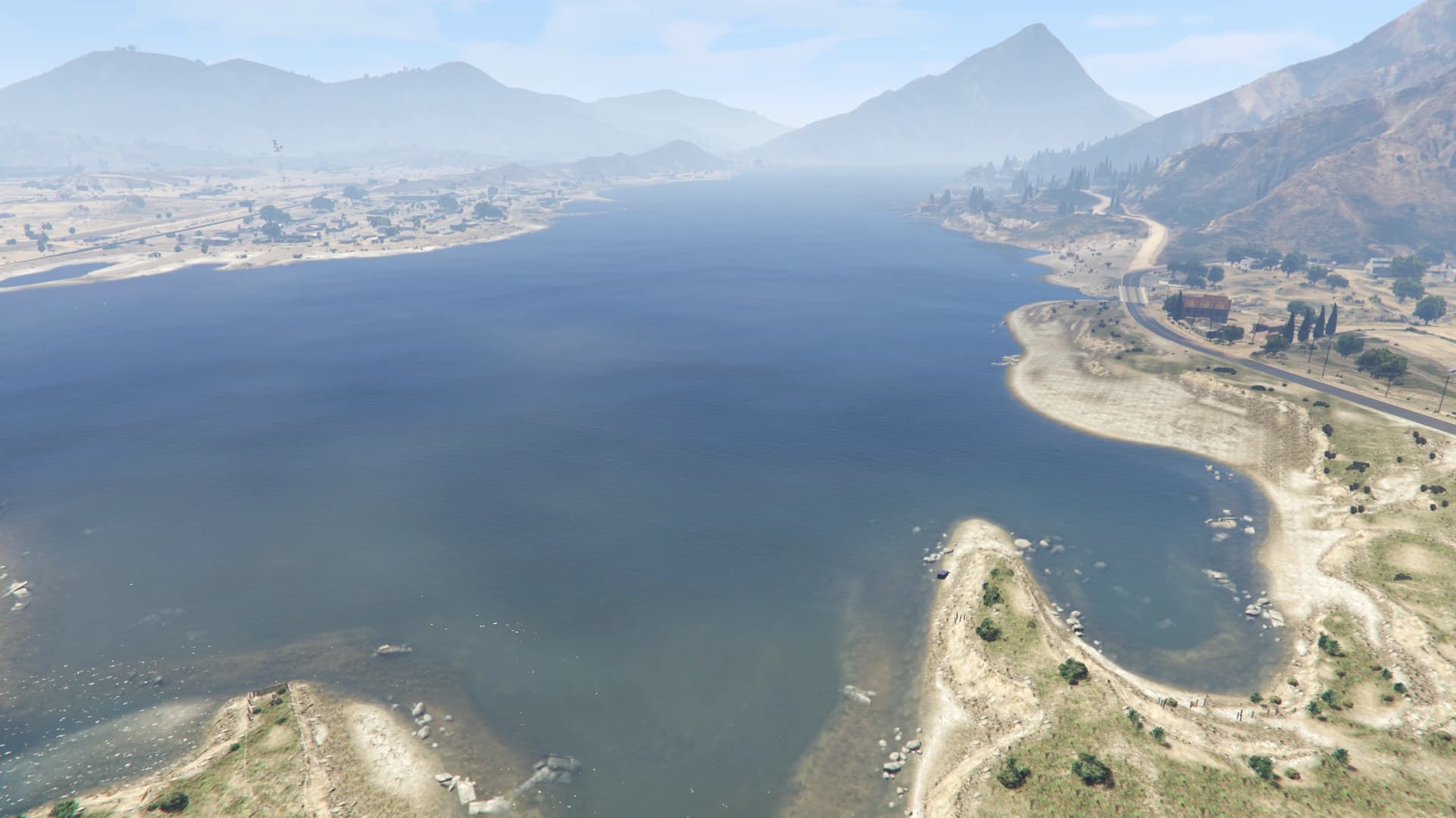 The Alamo Sea seen from the air, a wide inland lake ringed by scrub and bare desert mountains.