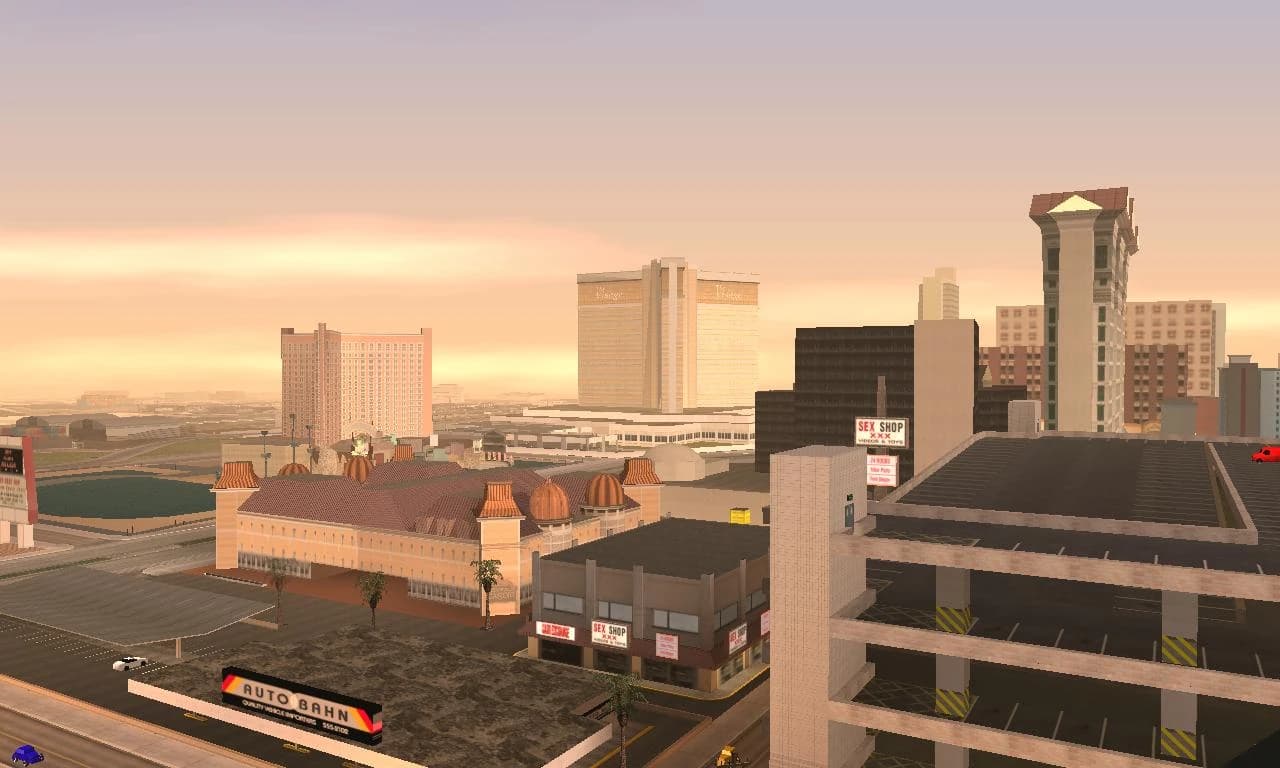 The Las Venturas strip at night, casino frontages lit end to end along the boulevard.
