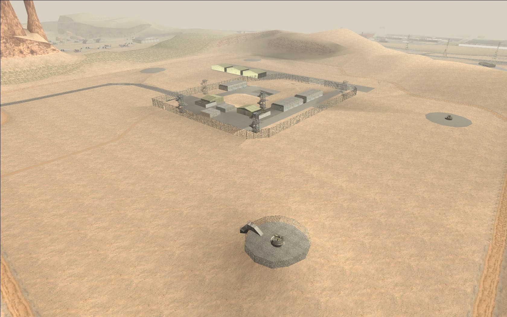 The fenced compound of Area 69 in the Bone County desert, hangars and antennae behind wire.