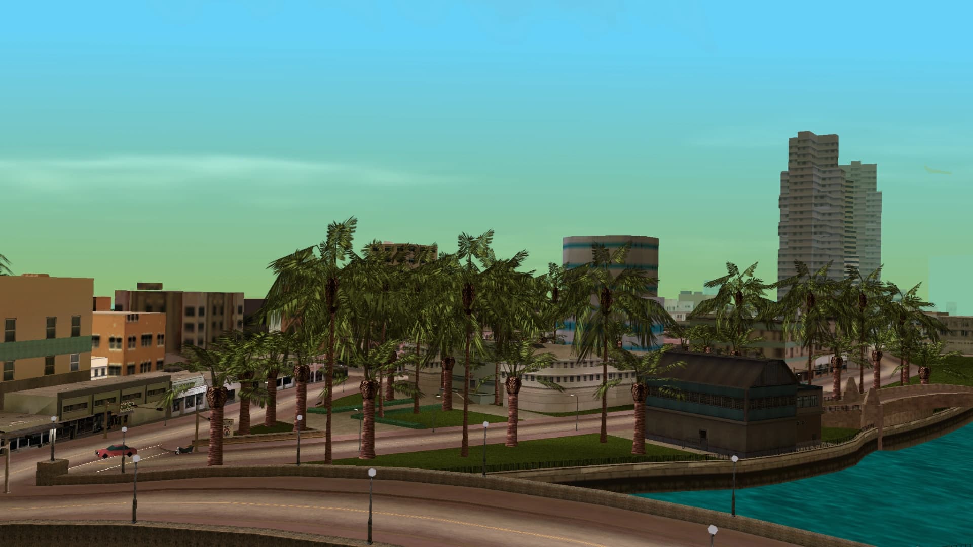 Washington Beach, low pastel blocks and palms along the shoreline road.