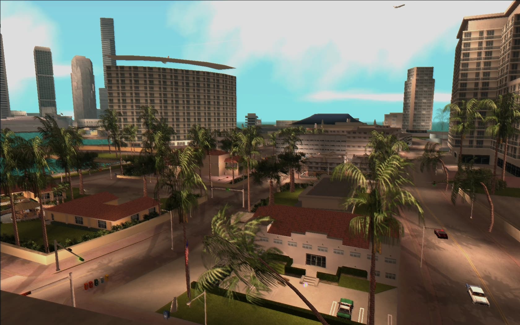 Vice Point's beachfront hotels and apartment blocks, palms along the road beside the sand.