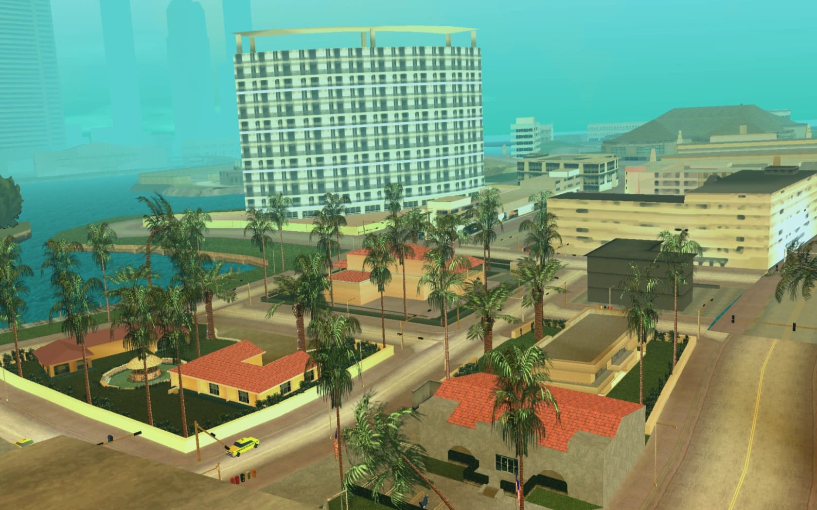 Vice Point, hotel blocks and low houses set back from the beach among palms.