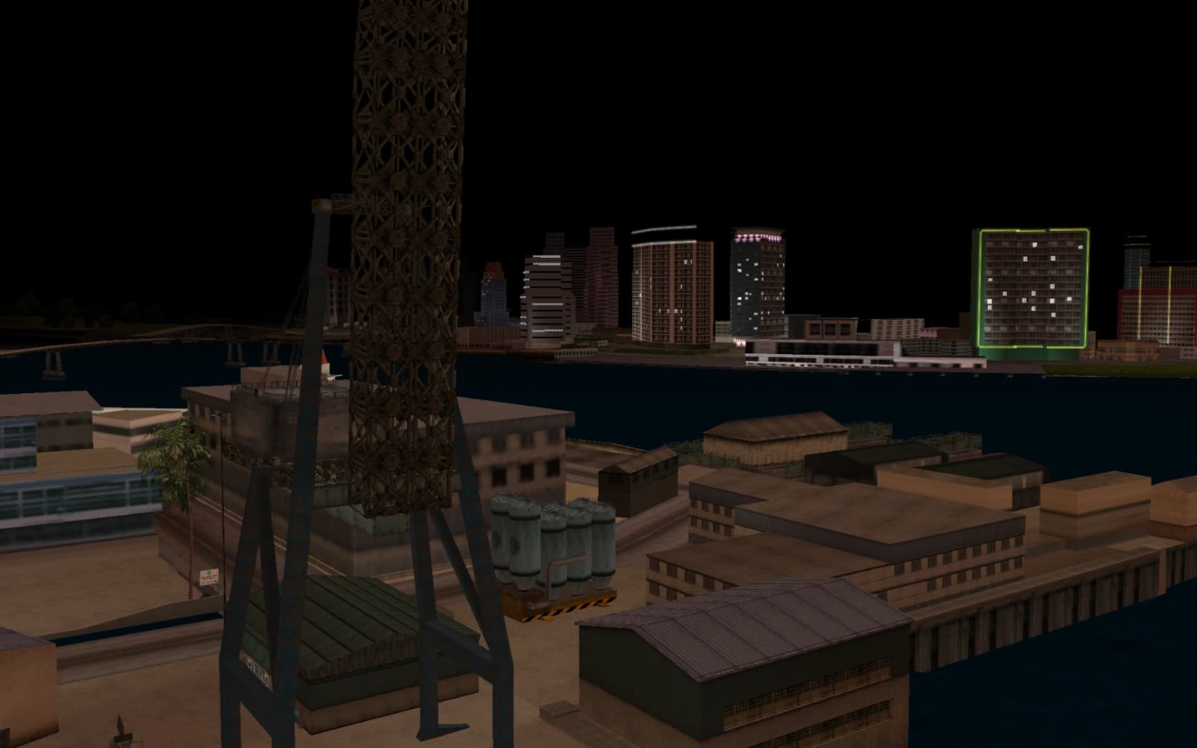 Viceport's docks at night, a loading crane above the quay with the city lit across the water.