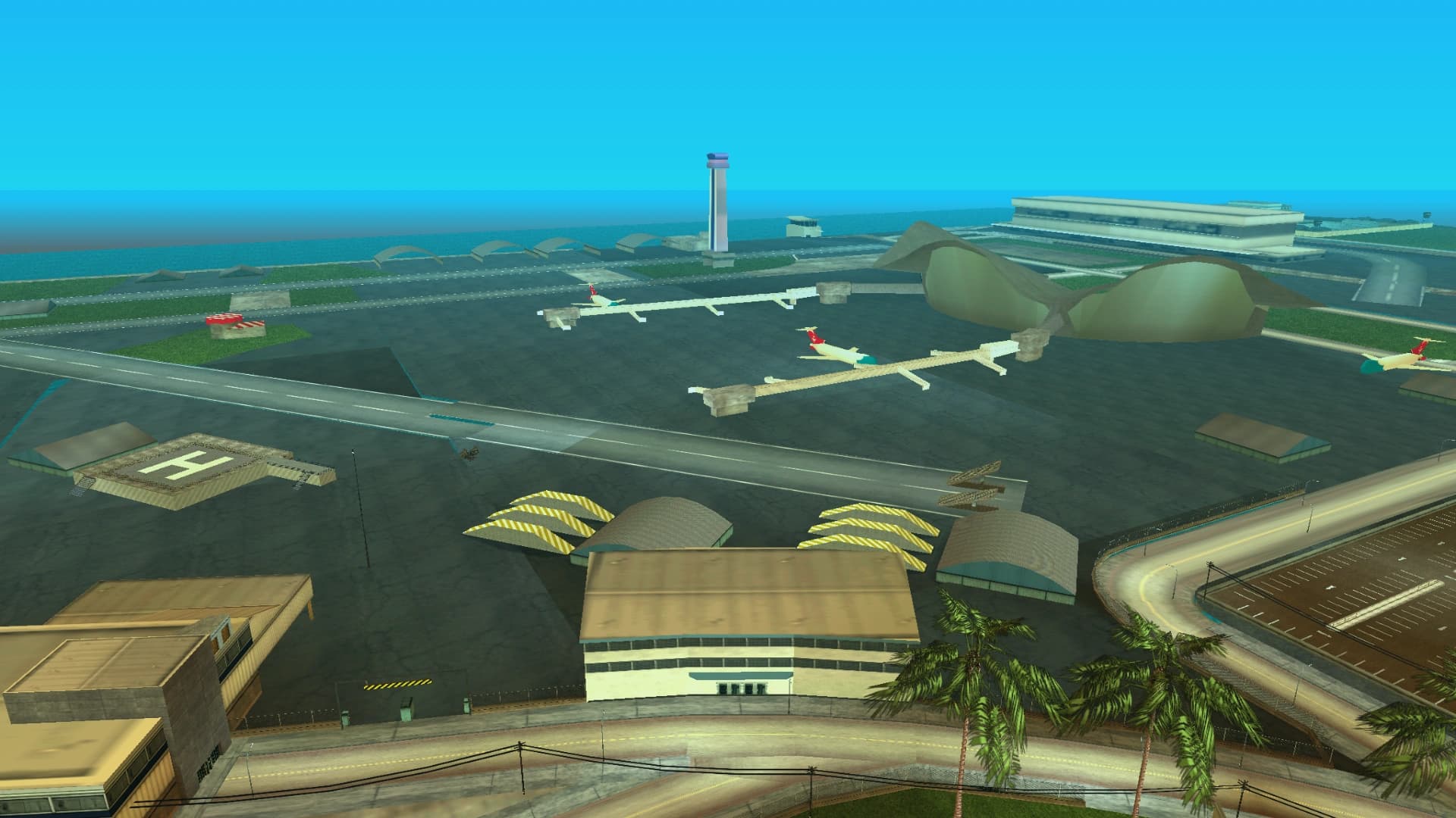 Escobar International Airport, its runway and control tower beside the sea with aircraft on the apron.