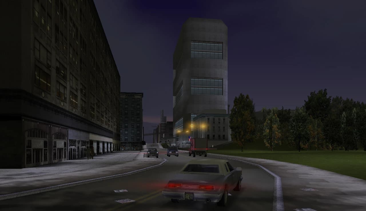Portland at night, its industrial streets and blocks under the lights with the water beyond.