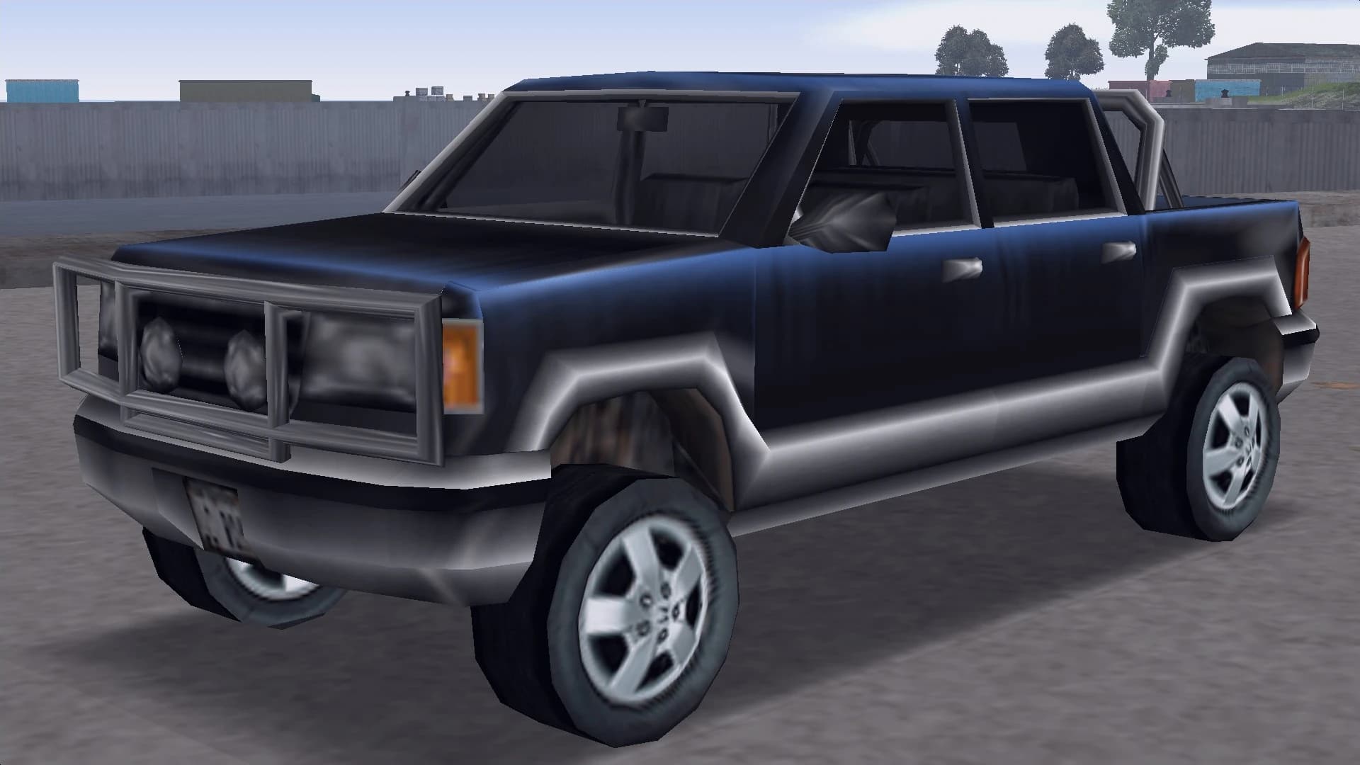 A dark blue crew-cab pickup fitted with a tubular bull bar, front three-quarter view.