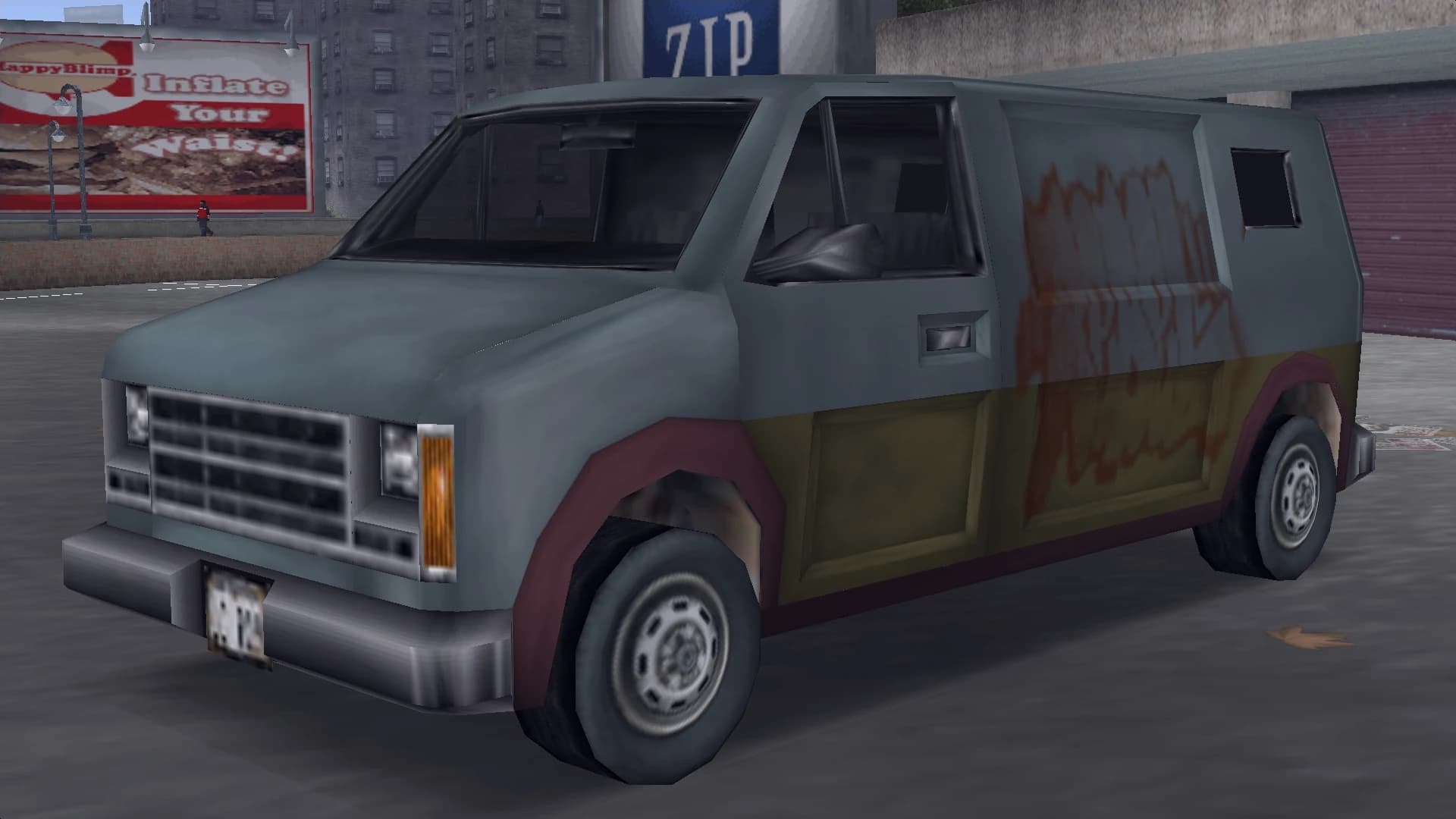 A grey and olive Hoods Rumpo XL van with graffiti along its flank, front three-quarter view.