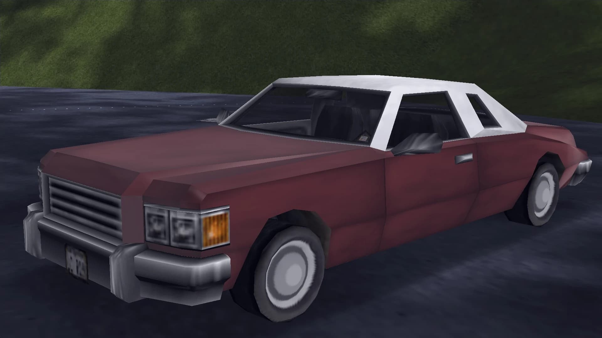 A dark red Idaho coupe with a white vinyl roof, front three-quarter view.