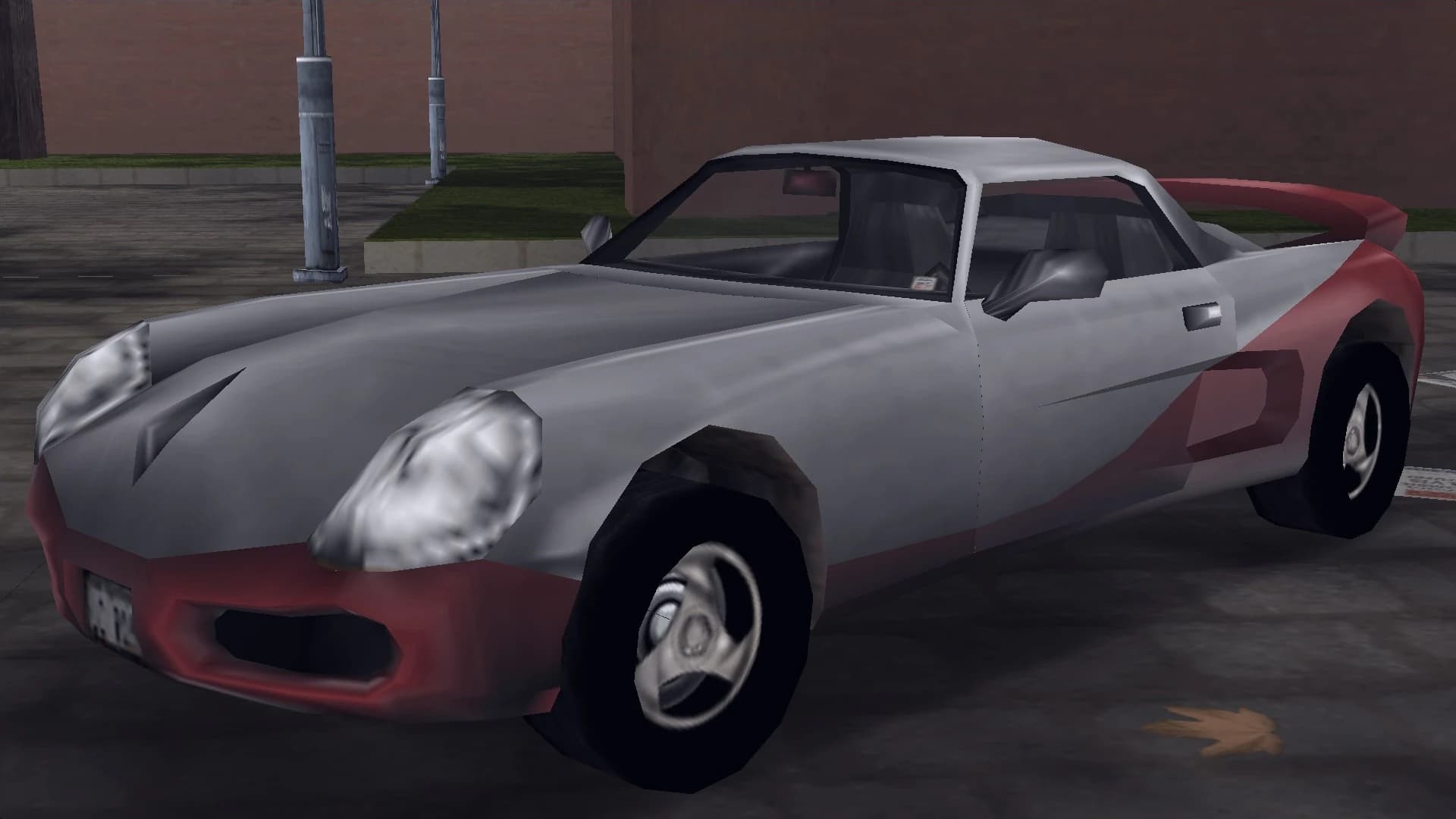 A silver and red Yakuza Stinger with a rear wing, front three-quarter view.