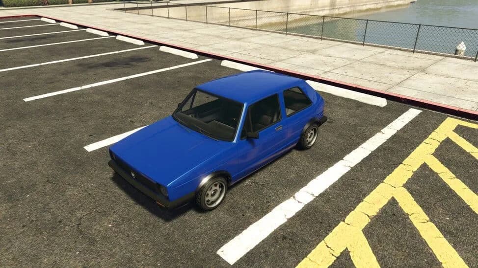 The BF Club, a blue three-door hatchback, parked in a car park by the water, in GTA Online.