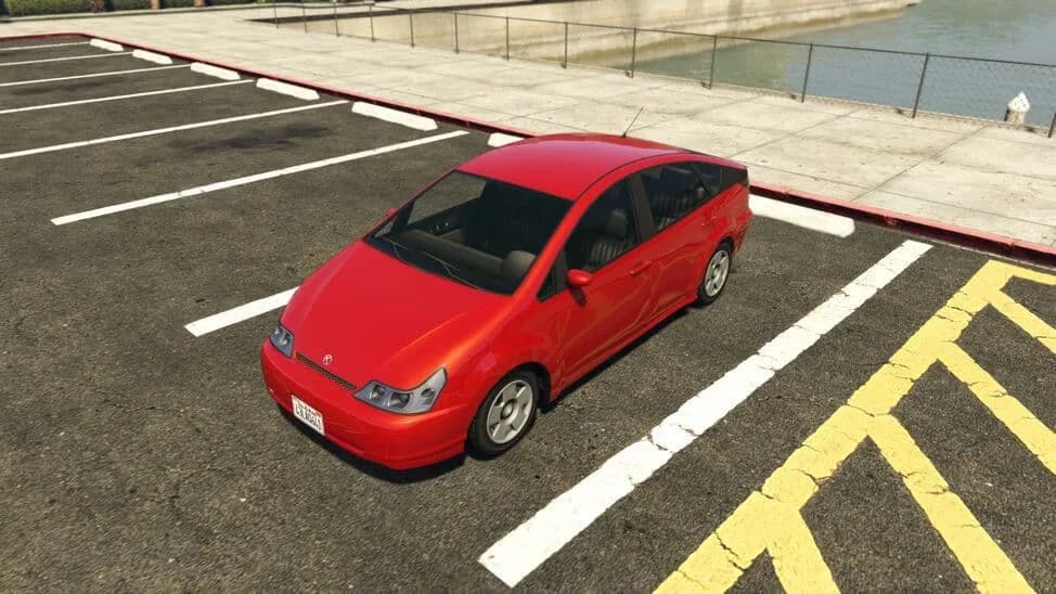 The Karin Dilettante, a red compact hybrid hatchback, parked in a car park by the water, in GTA Online.