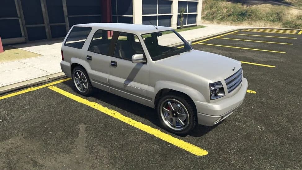 The Albany Cavalcade, a silver full-size SUV, parked in a car park, in GTA Online.