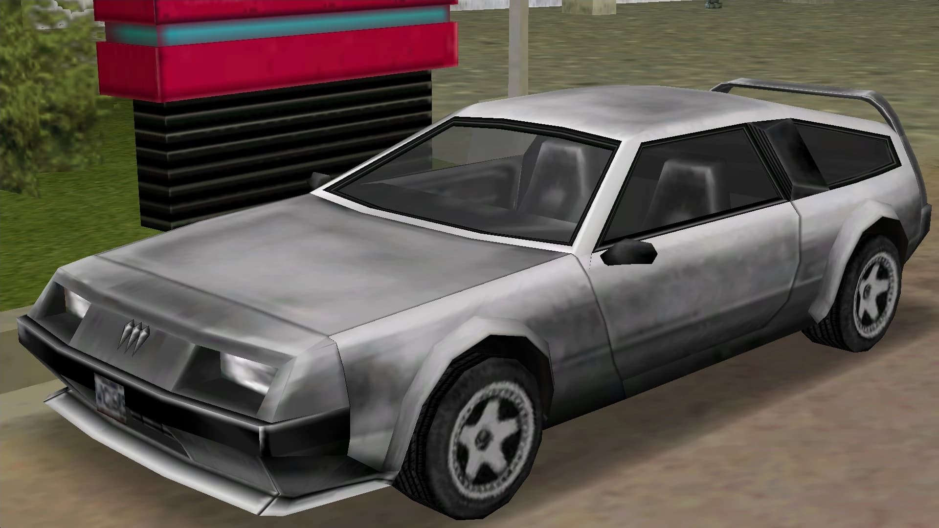 A silver Deluxo wedge coupe with a rear spoiler, front three-quarter view.