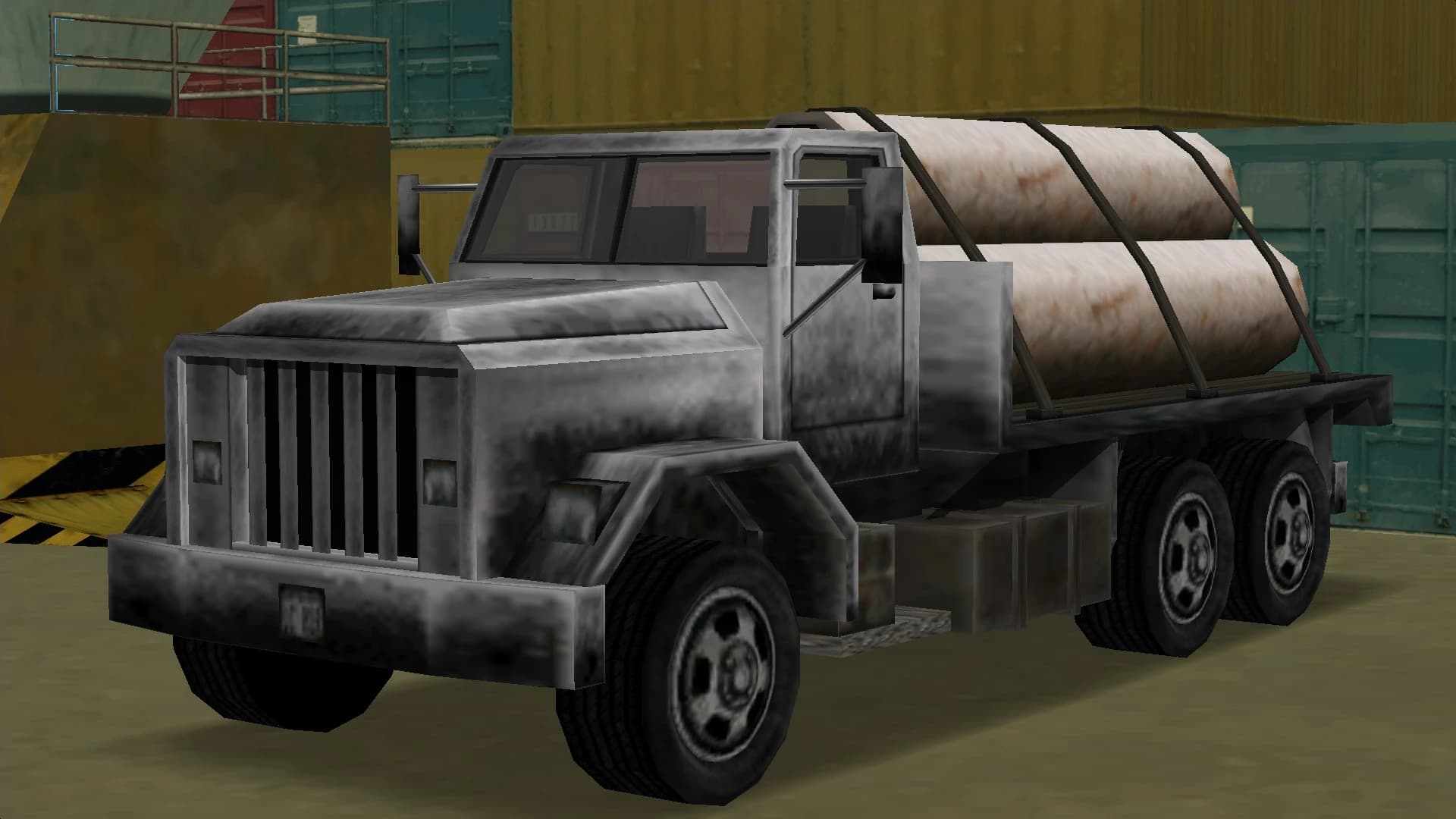 A grey Flatbed lorry carrying strapped pipes, front three-quarter view.
