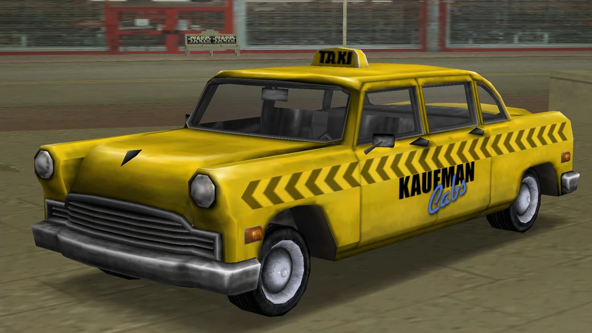 A yellow Kaufman Cabs taxi with a chevron stripe and a TAXI roof sign, front three-quarter view.