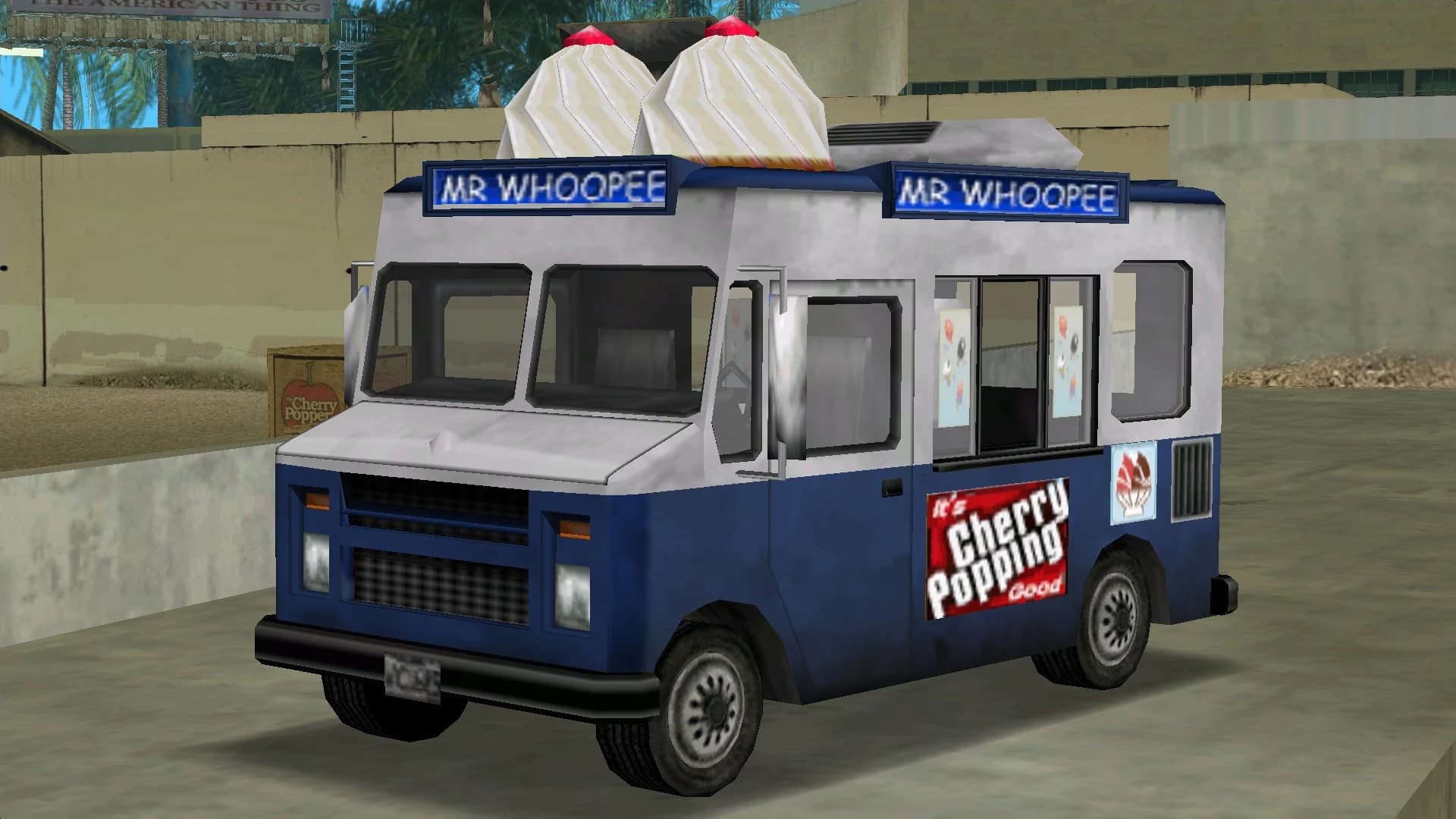 A blue and white Mr Whoopee ice cream van with cones on its roof, front three-quarter view.