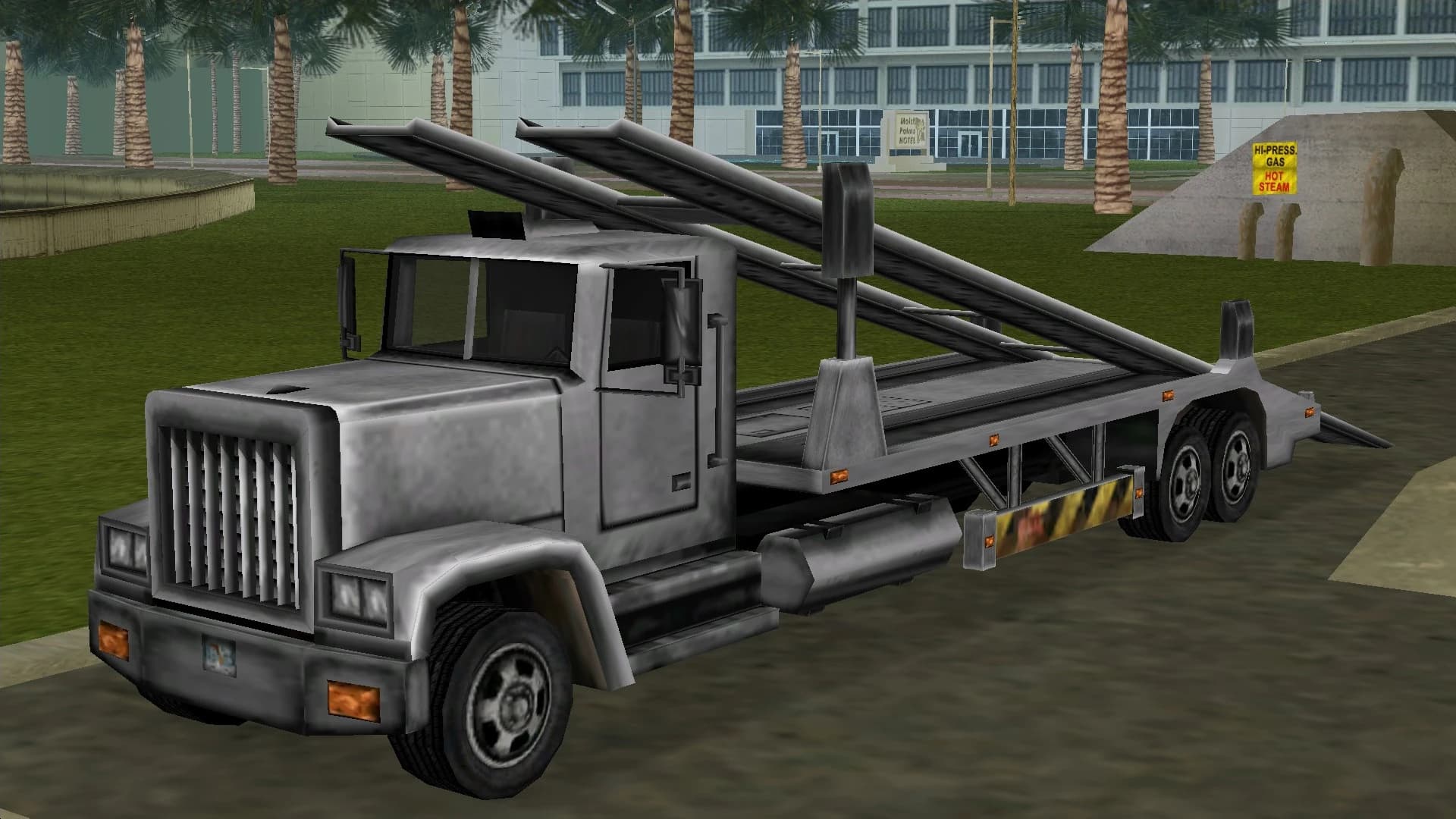 A grey Packer car transporter with its loading ramps raised, front three-quarter view.