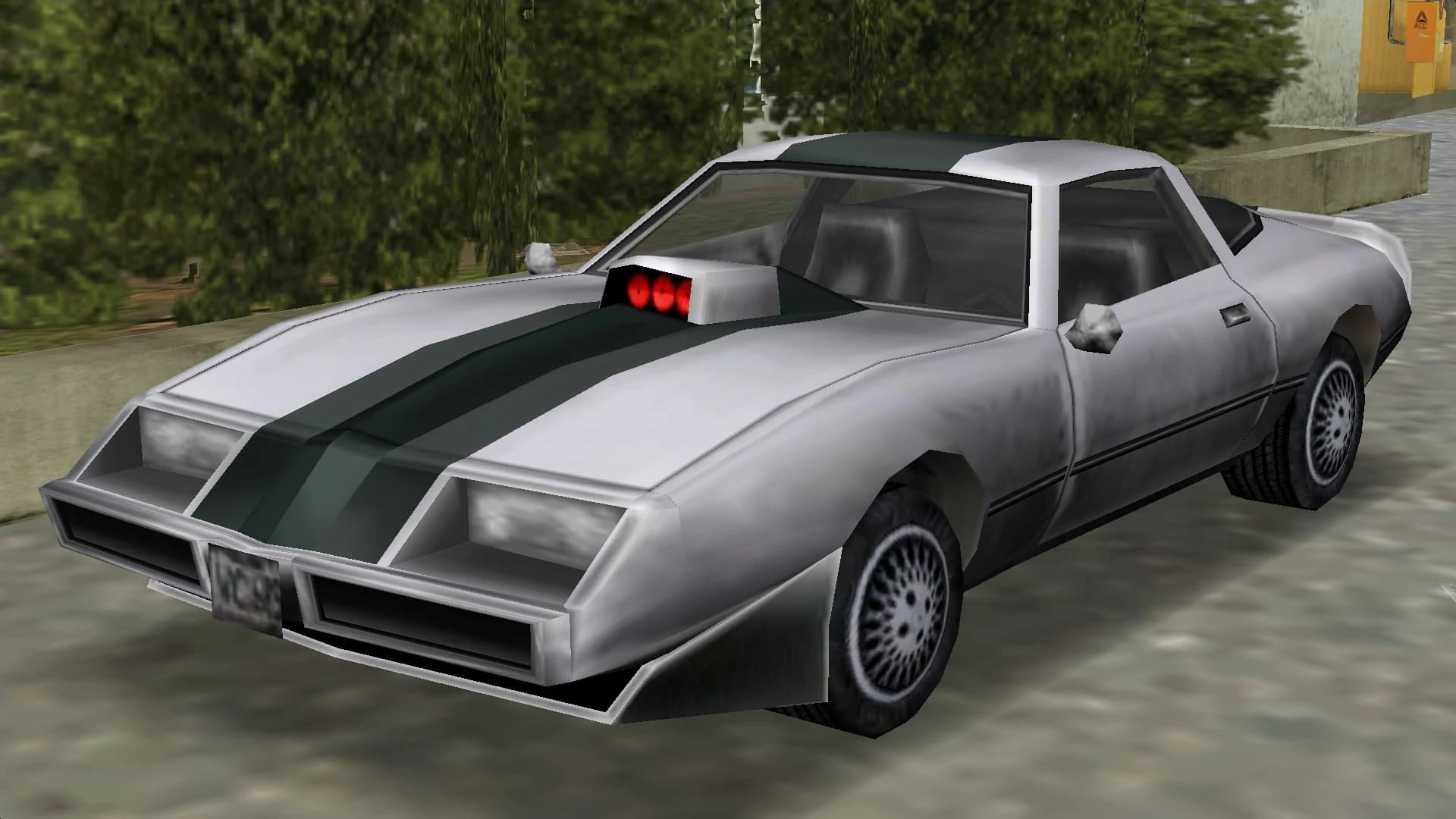A silver Phoenix muscle car with a dark bonnet stripe and a bonnet scoop, front three-quarter view.
