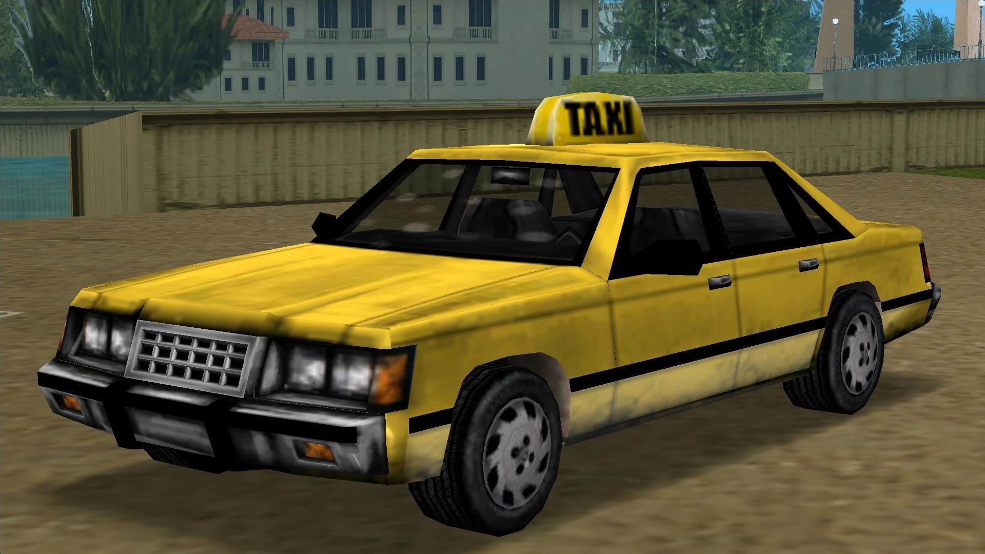 A yellow Taxi saloon with a TAXI roof sign, front three-quarter view.