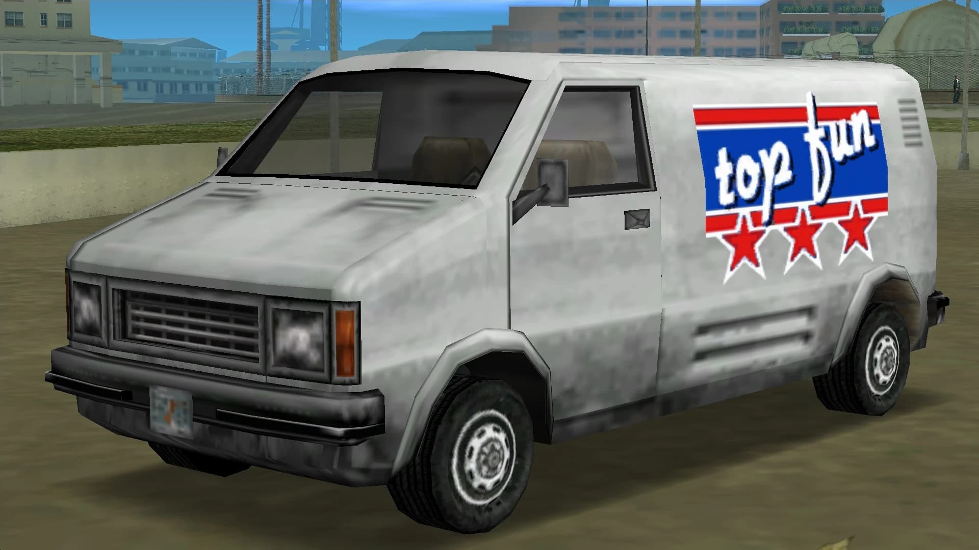 A white Top Fun van with a red, white and blue logo on its flank, front three-quarter view.