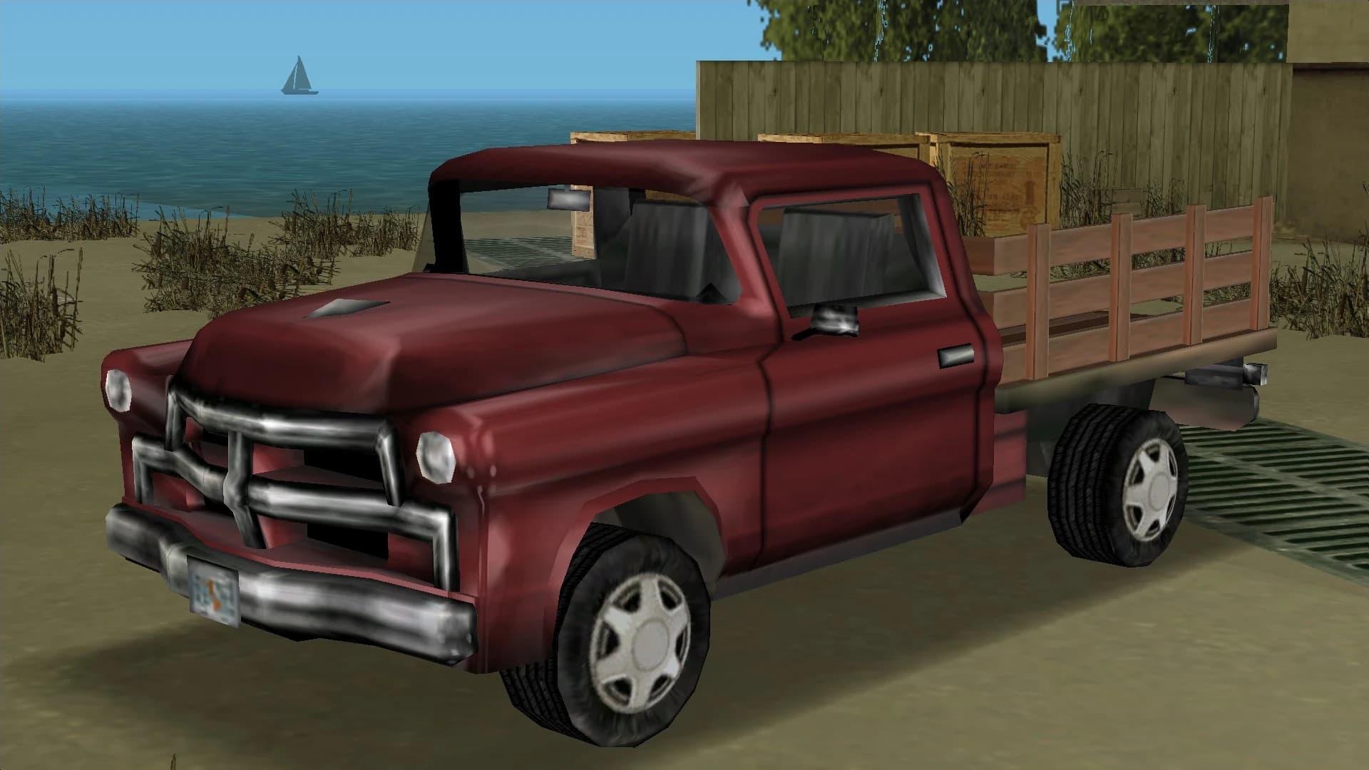 A red Walton pickup with wooden stake sides, front three-quarter view.