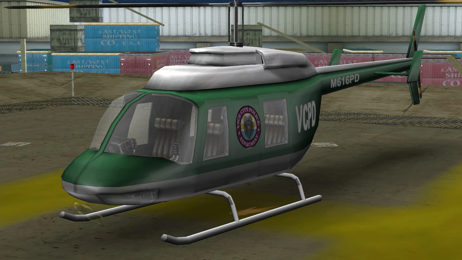 A green and white VCPD Police Maverick helicopter, on a helipad.