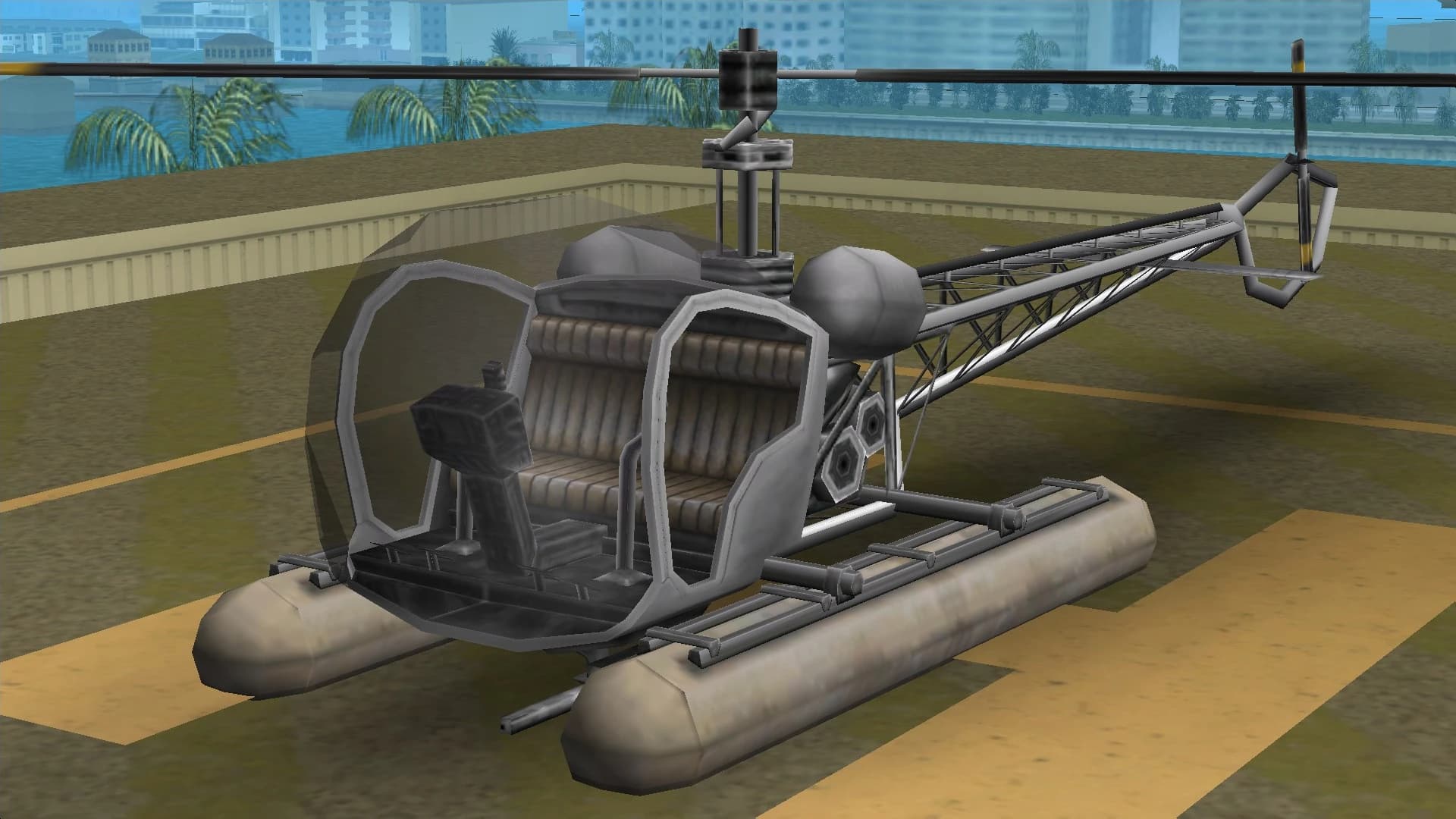 A grey Sea Sparrow light helicopter on pontoon floats, on a helipad.