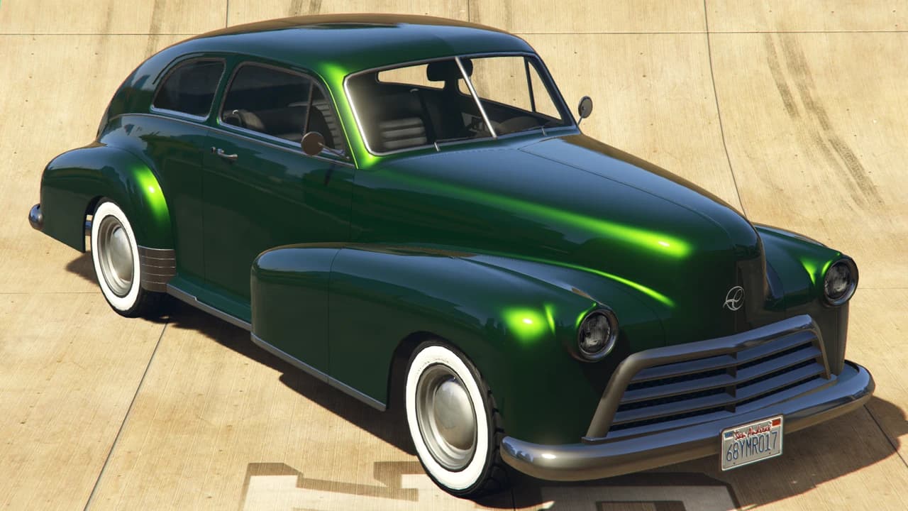 A dark green Classique Broadway lowrider on whitewall tyres, front three-quarter view.