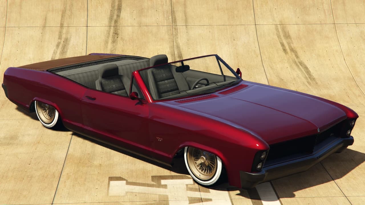A red Albany Buccaneer Custom convertible lowrider on wire wheels, front three-quarter view.