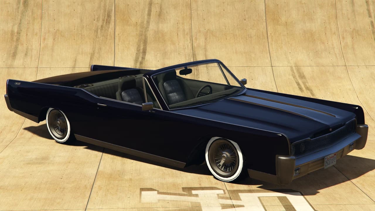 A dark navy Vapid Chino Custom convertible lowrider on wire wheels, front three-quarter view.