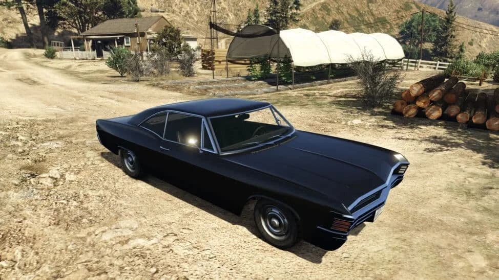 The Declasse Impaler, a black late-1960s two-door hardtop, parked on a dirt yard, in GTA Online.
