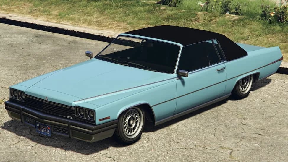 The Albany Manana Custom, a pale blue lowered 1970s coupe with a black vinyl roof, parked by a roadside verge, in GTA Online.