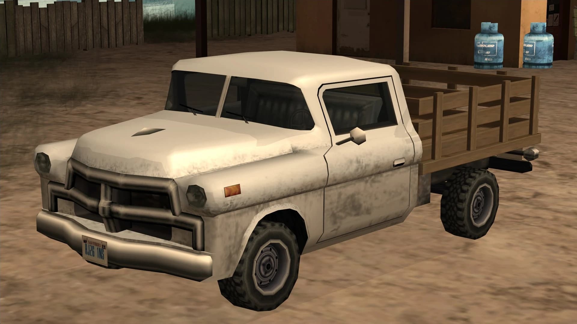 The Walton, an old flatbed pickup with wooden side rails, front three-quarter view.