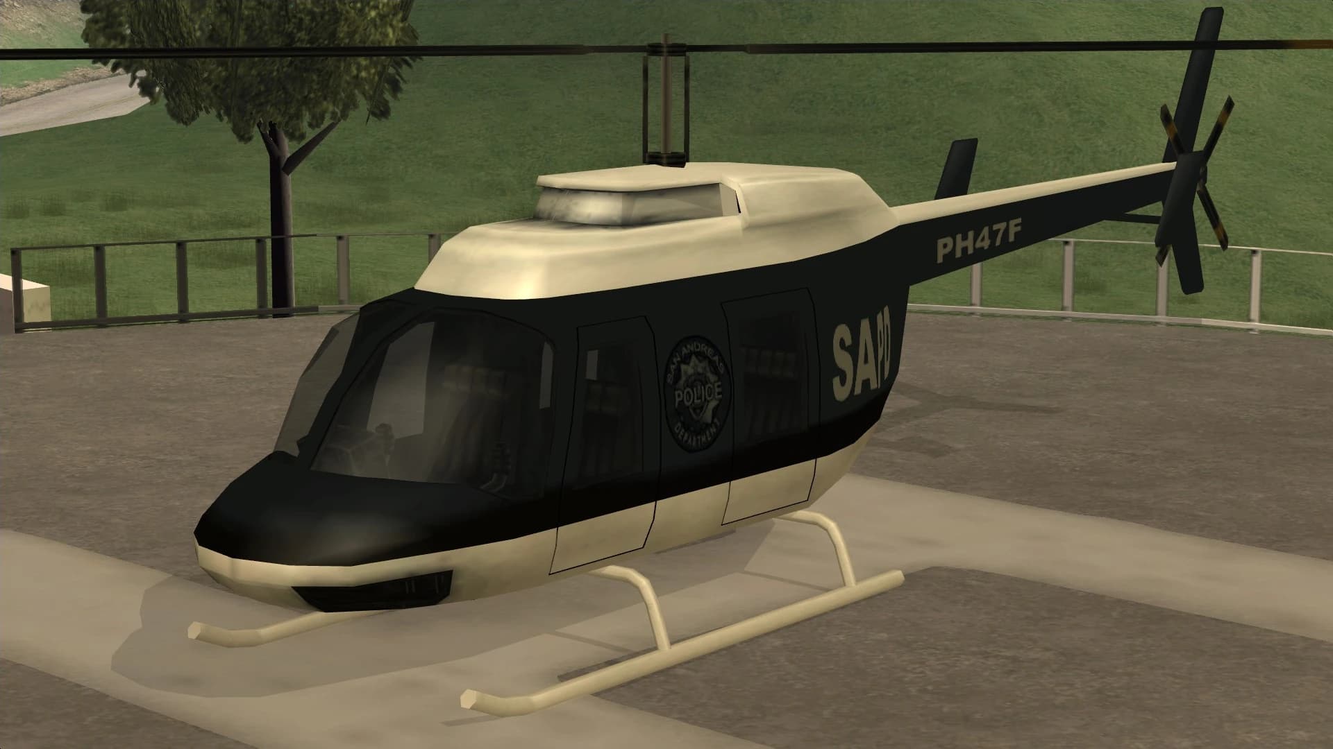 The Police Maverick, a light helicopter in San Andreas Police Department livery, on a helipad, front three-quarter view.