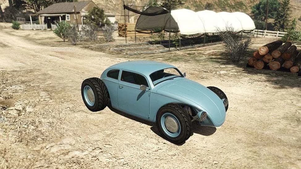 The BF Weevil Custom, a pale blue hot-rodded beetle-shaped car with big rear tyres, parked on a dirt yard, in GTA Online.