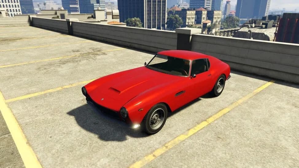 The Grotti GT500, a red 1960s grand touring coupe, parked on a rooftop car park, in GTA Online.