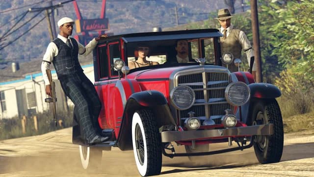 A red Albany Roosevelt 1920s saloon with white-wall tyres and two passengers on the running boards, in GTA Online.