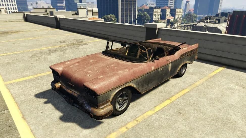 The Declasse Tornado Mariachi, a rusted late-1950s convertible, parked on a rooftop car park, in GTA Online.