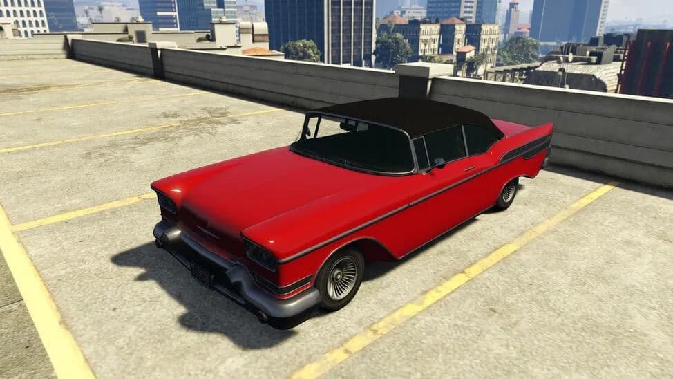 The Declasse Tornado Custom, a red lowered late-1950s hardtop with a black roof, parked on a rooftop car park, in GTA Online.