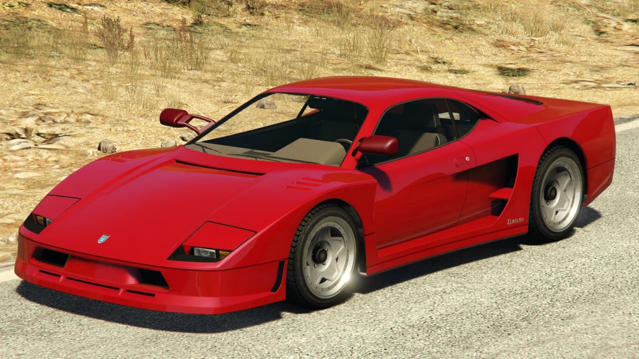 A red Grotti Turismo Classic on a desert road.
