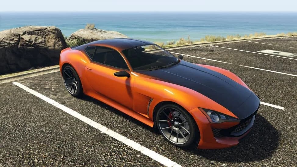 The Lampadati Furore GT, an orange grand tourer with a black bonnet and roof, parked by the coast, in GTA Online.