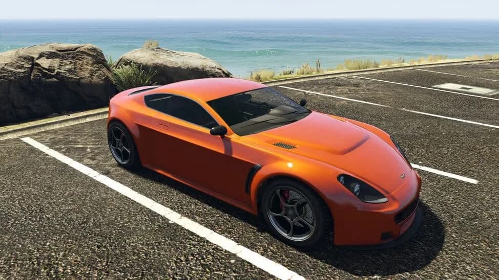 The Dewbauchee Rapid GT, an orange modern grand touring coupe, parked by the coast, in GTA Online.